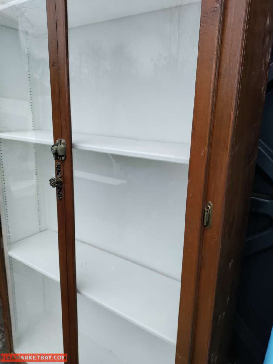 two very tall vanities or display cases