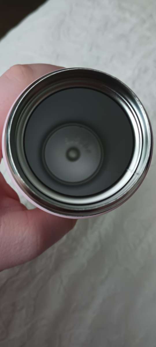 A steel drinking cup thermos