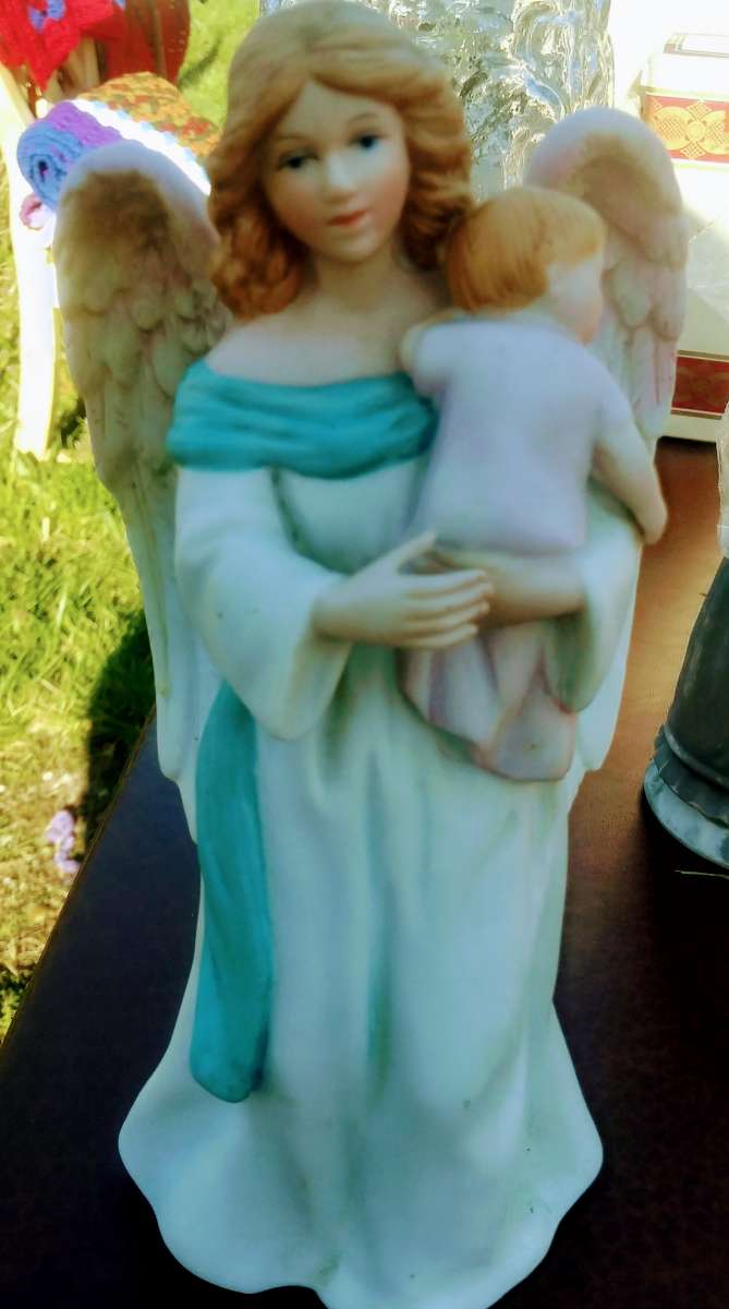 ANGELIC ANGEL HOLDING BABY