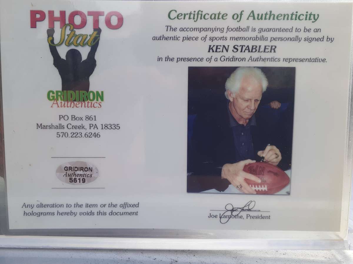 an autographed Ken Stabler football in an acrylic case