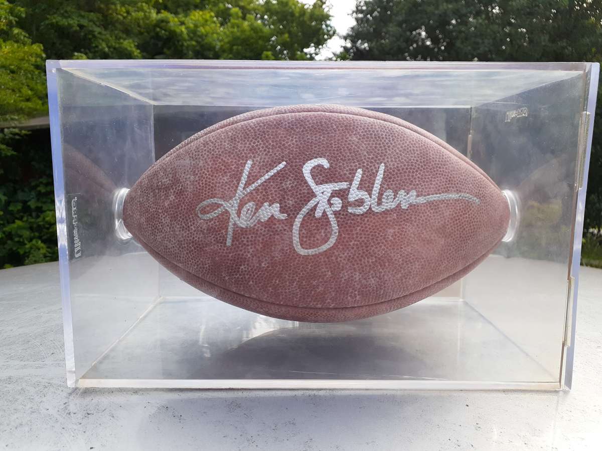 an autographed Ken Stabler football in an acrylic case