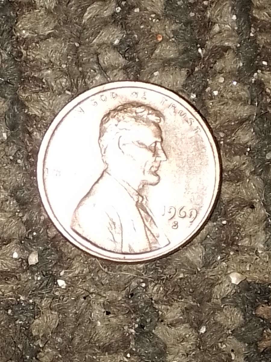 1957 d wheat penny with obverse error on the b on liberty