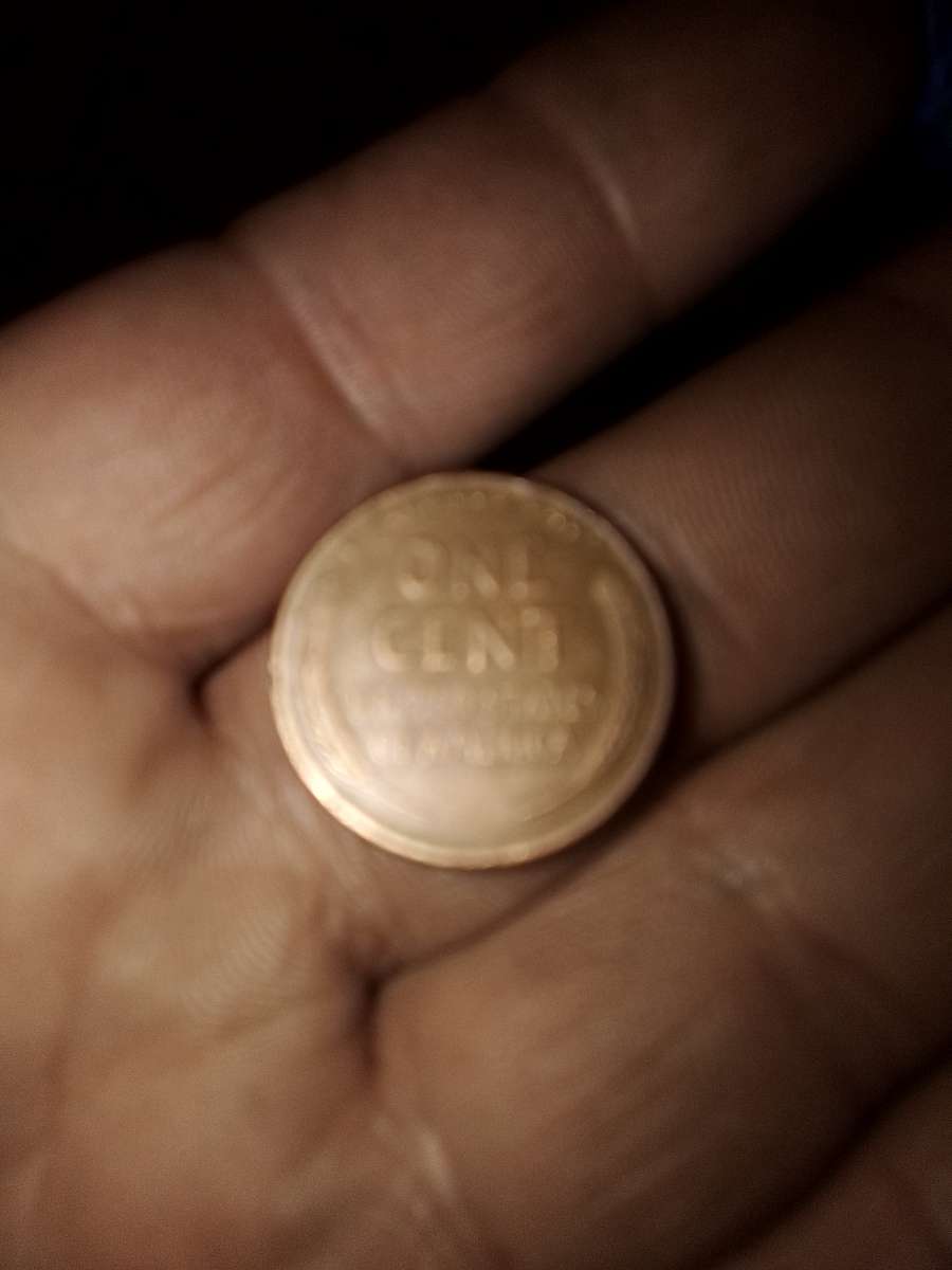 1957 d wheat penny with obverse error on the b on liberty
