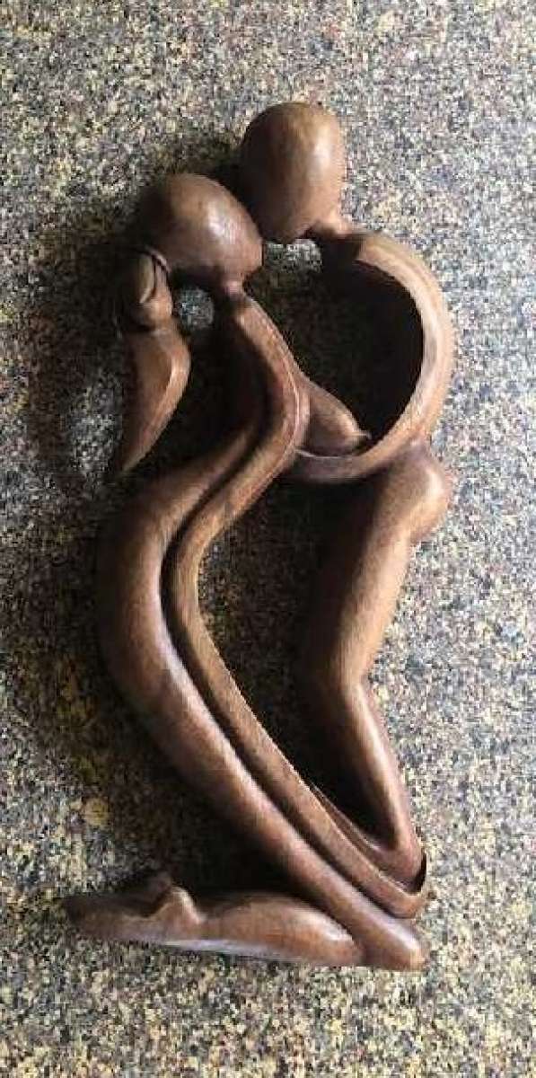wood sculpture man  woman kissing