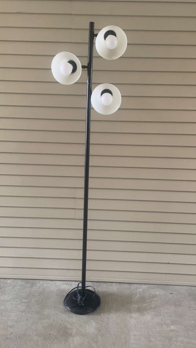 tall black lamp with three head lights