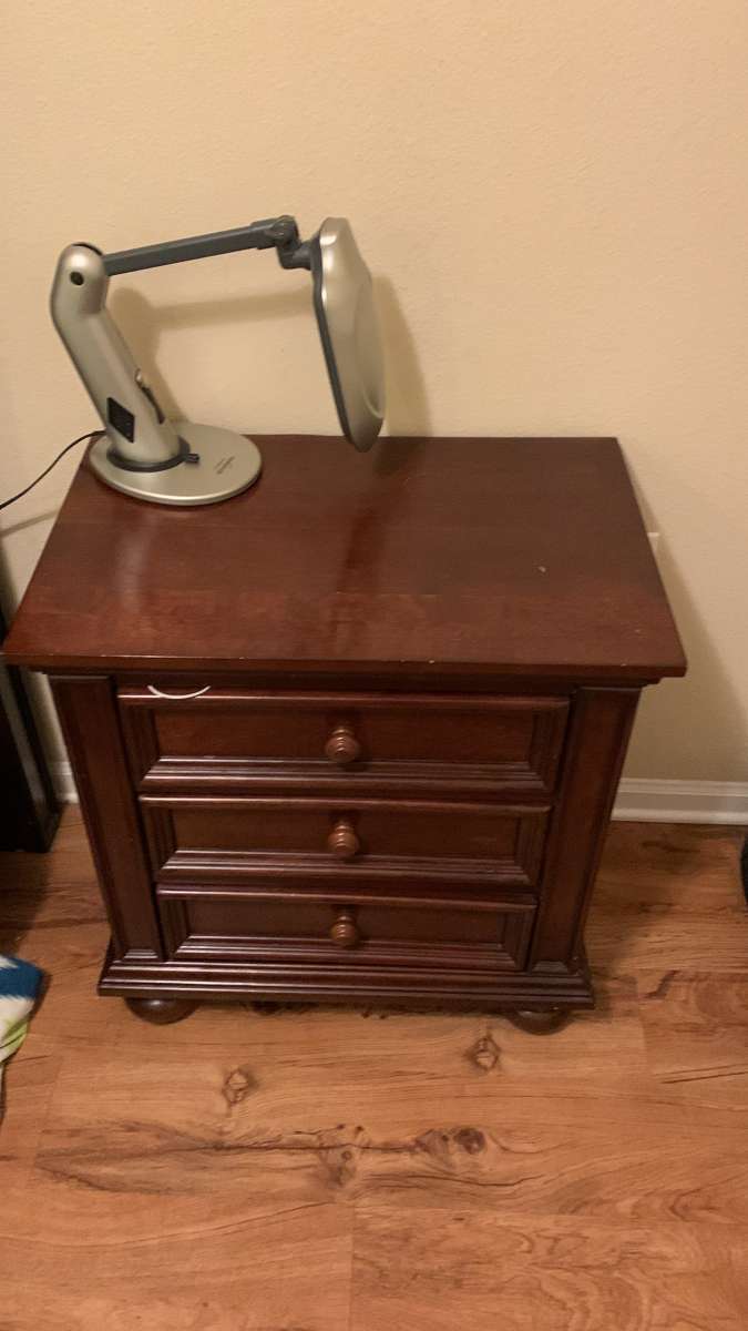 a couch a bed a dresser and a tv stand and a side table