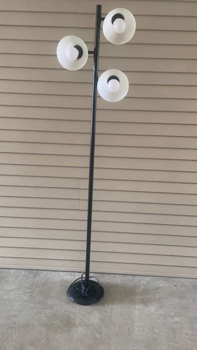 tall black lamp with three head lights