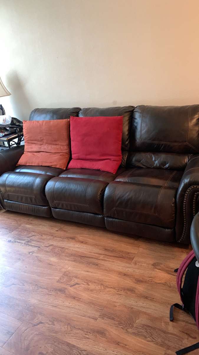 a couch a bed a dresser and a tv stand and a side table