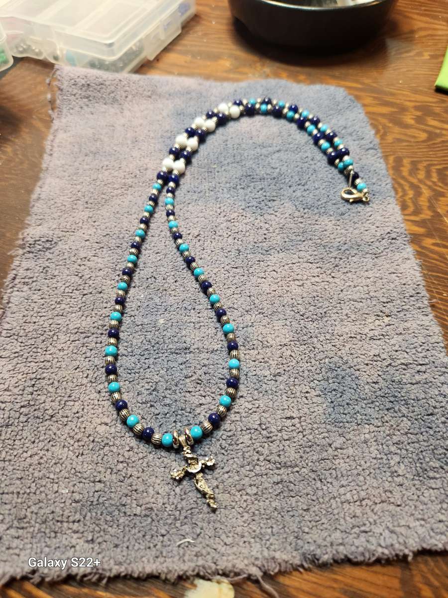 silver cross with glass bead necklace
