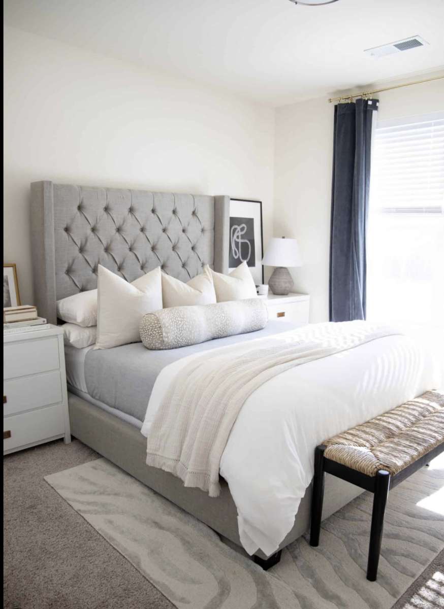 gray bed set including the binch at the end of bed