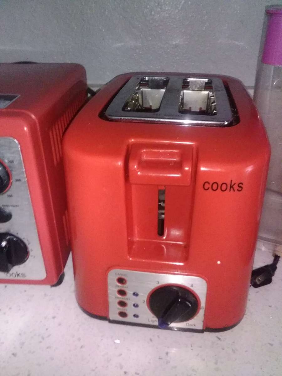a red conventional oven with toaster from the brand Cooks