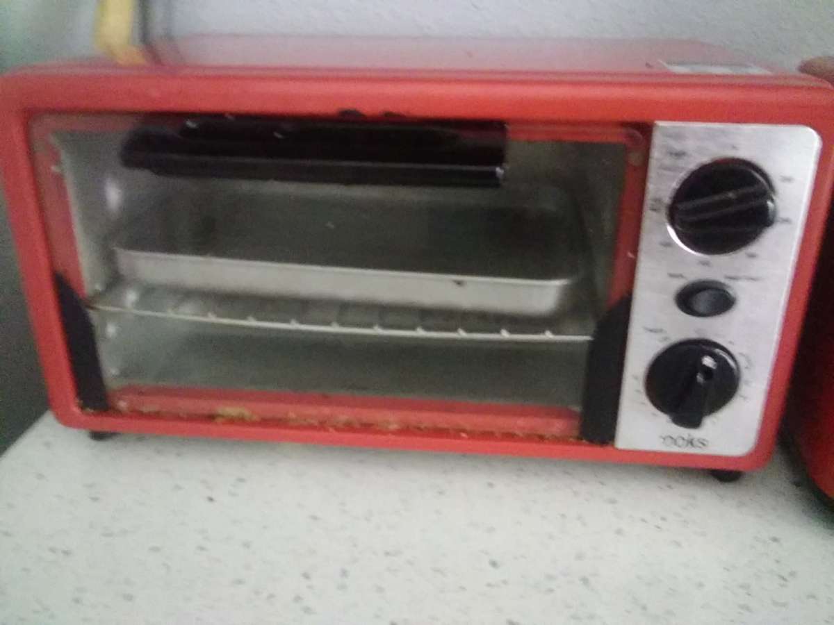 a red conventional oven with toaster from the brand Cooks