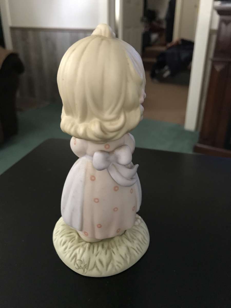 precious moment girl holding a cake