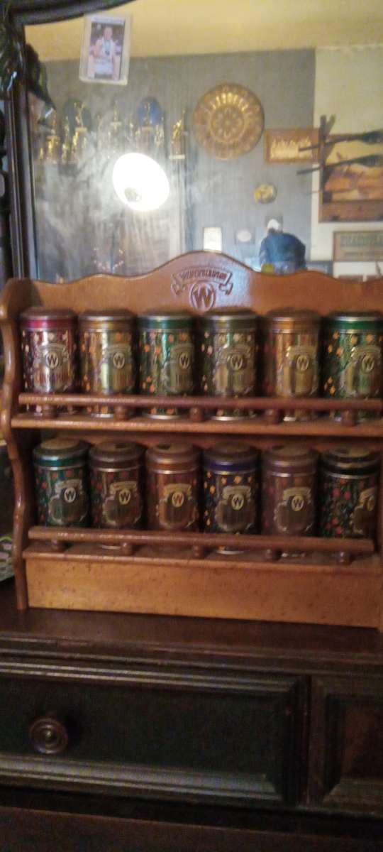 vintage spice cabinet with metal spice tins