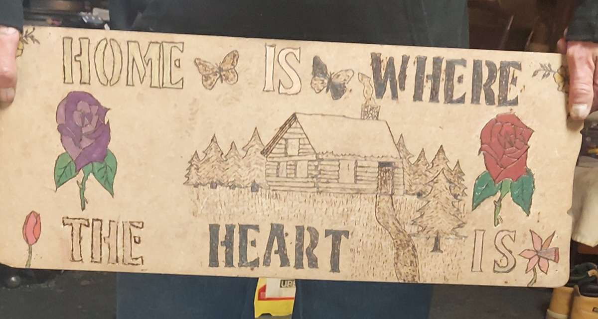 wood burned sighn home is where the heart is