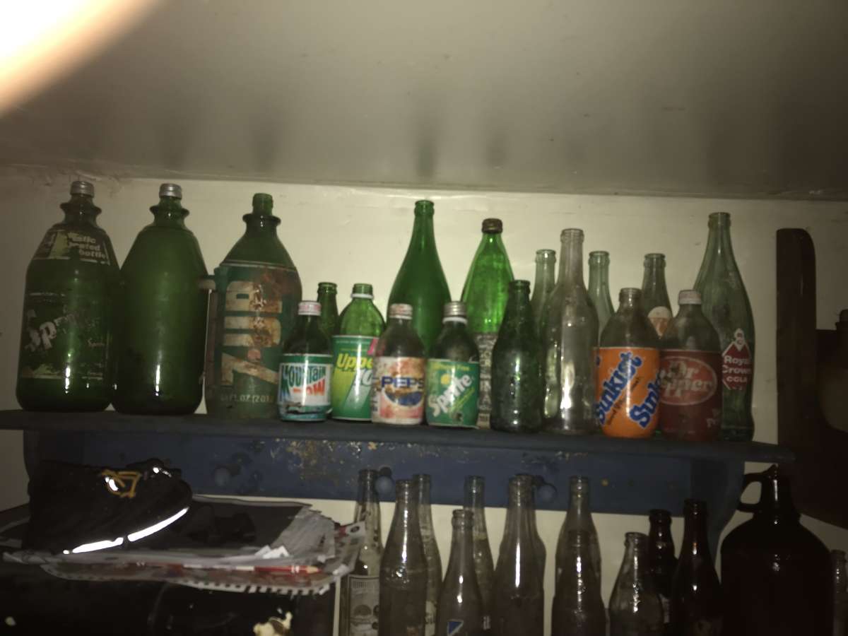 old soda bottles and beer bottles and others