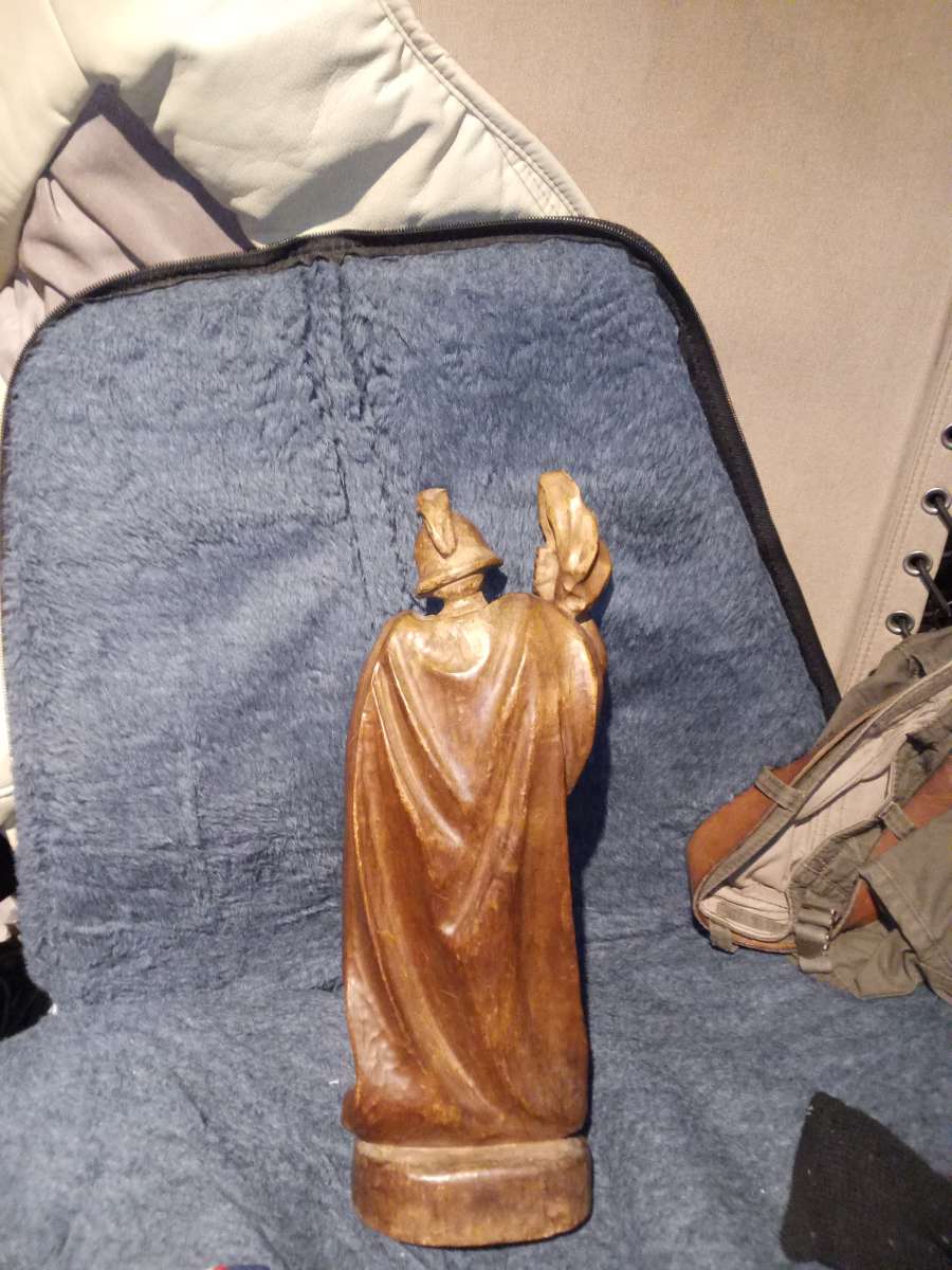 wood carving of a Roman firefighter