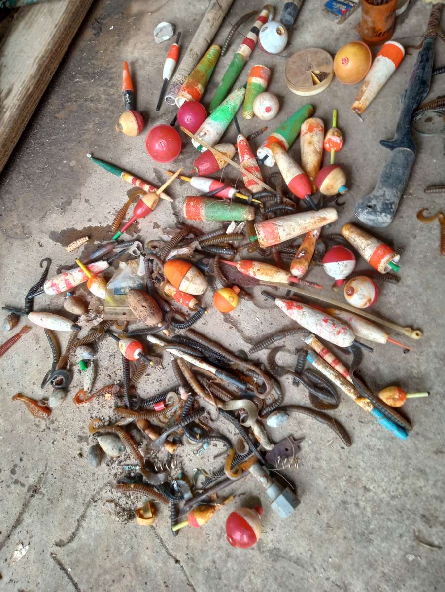 old boat parts and fishing poles and tackle