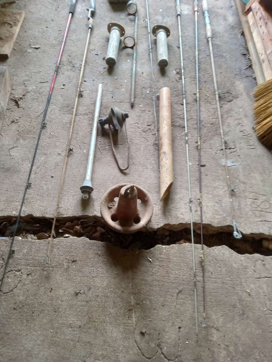 old boat parts and fishing poles and tackle