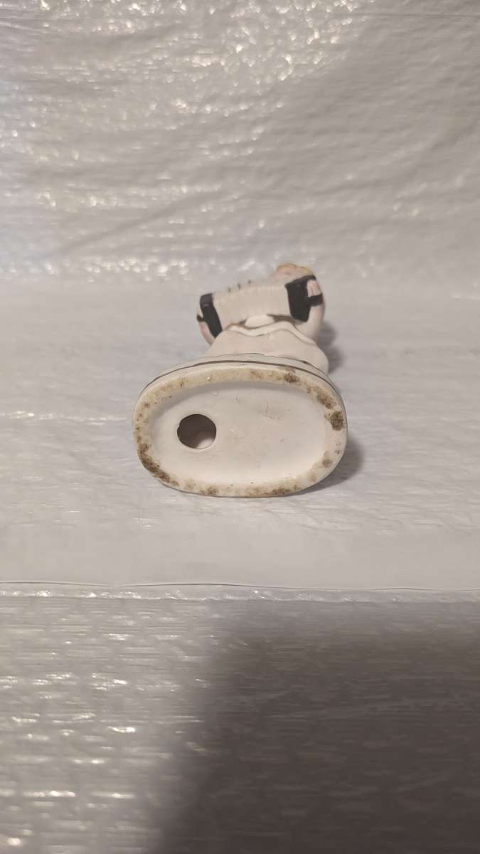 A Little Girl Playing an Accordion with a White Dress