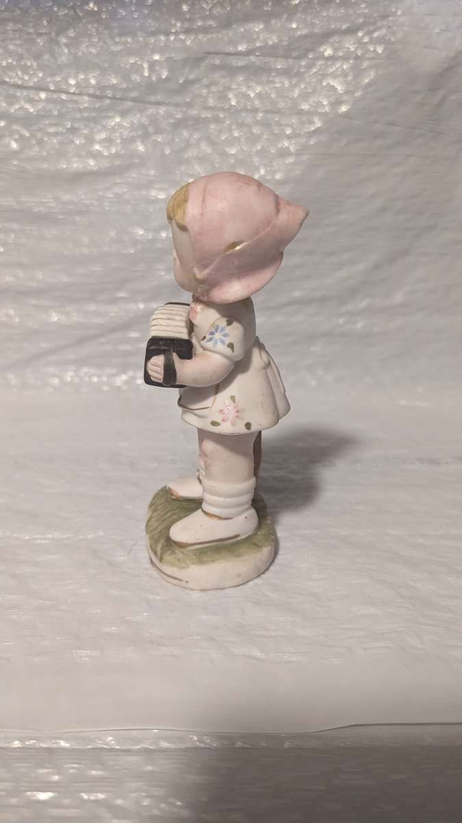 A Little Girl Playing an Accordion with a White Dress