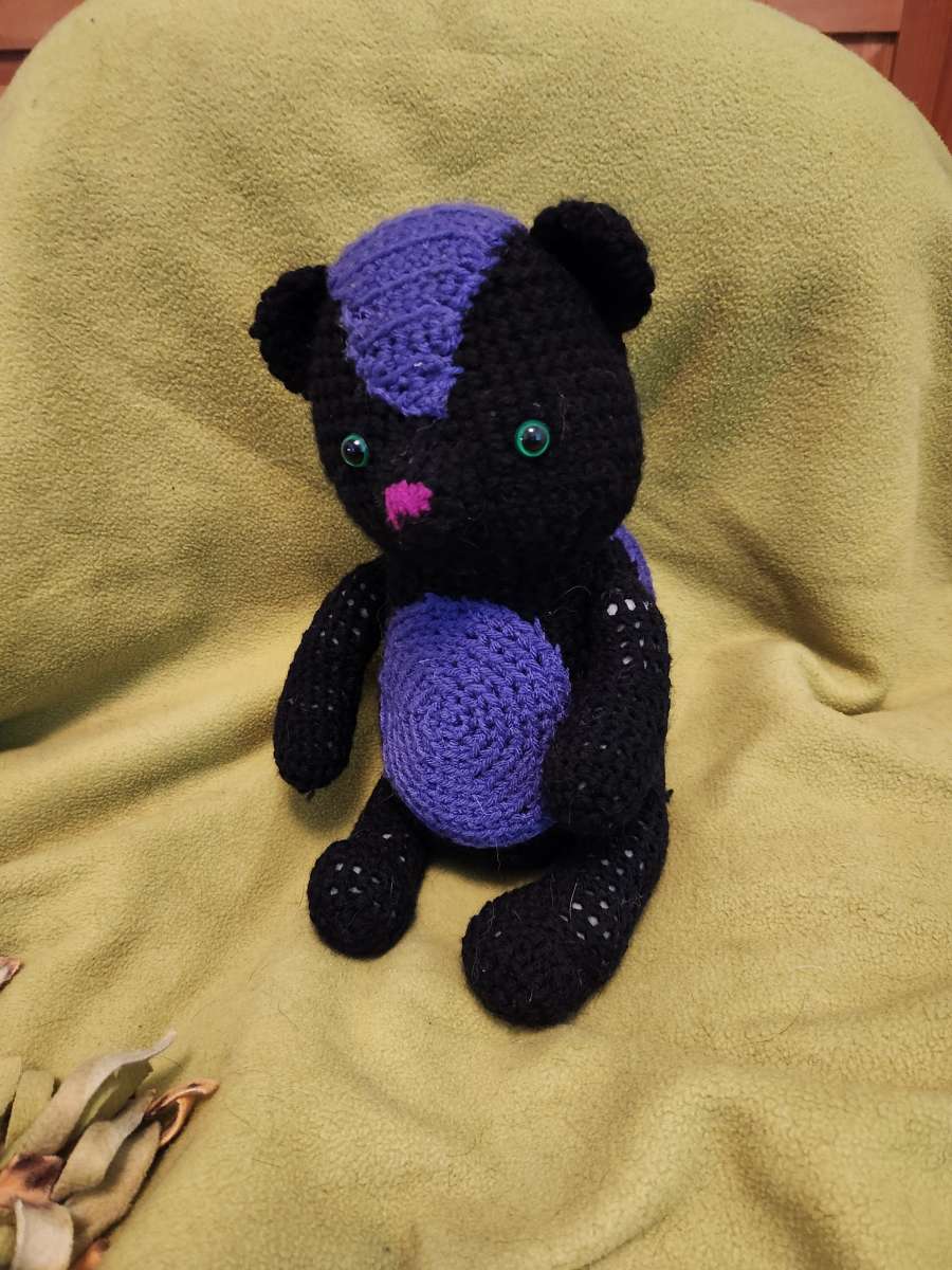 Spunky the black and purple Skunk