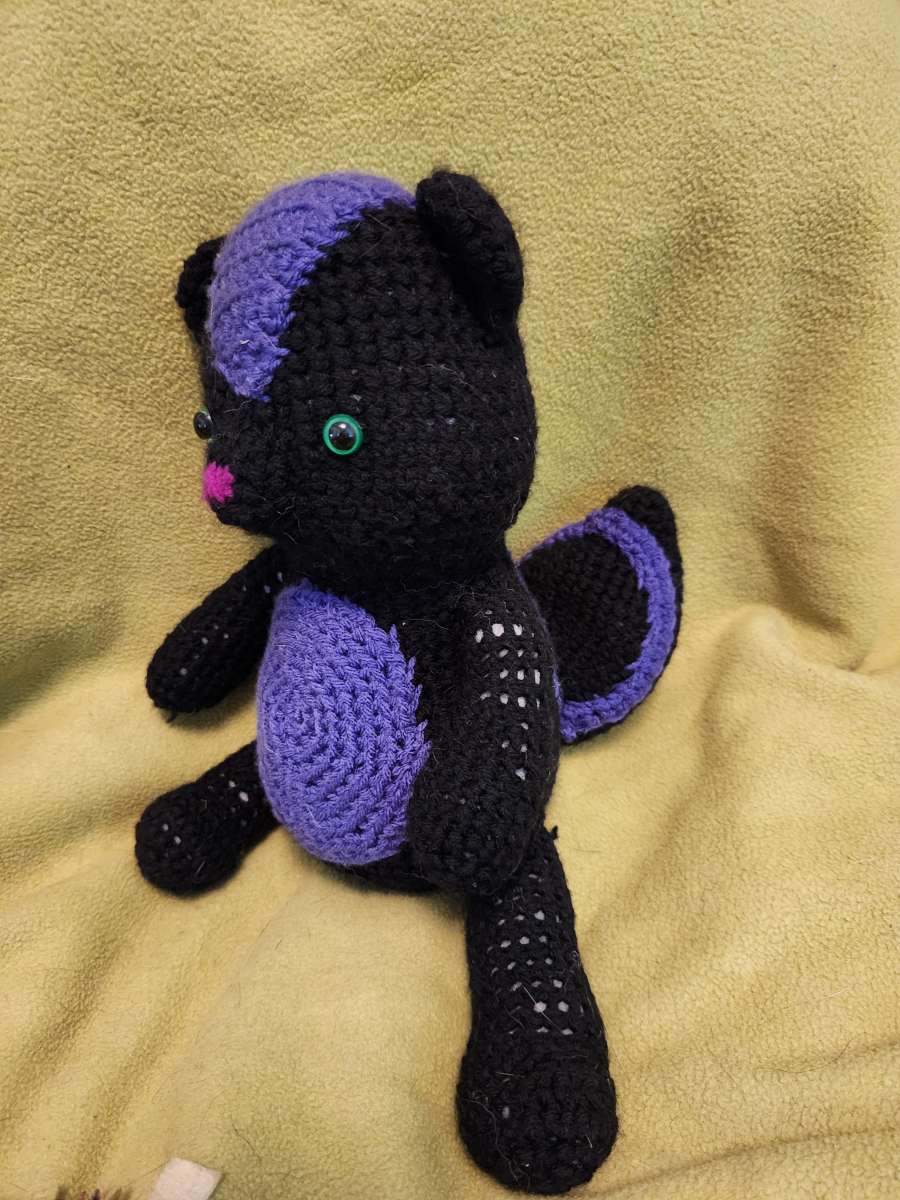 Spunky the black and purple Skunk