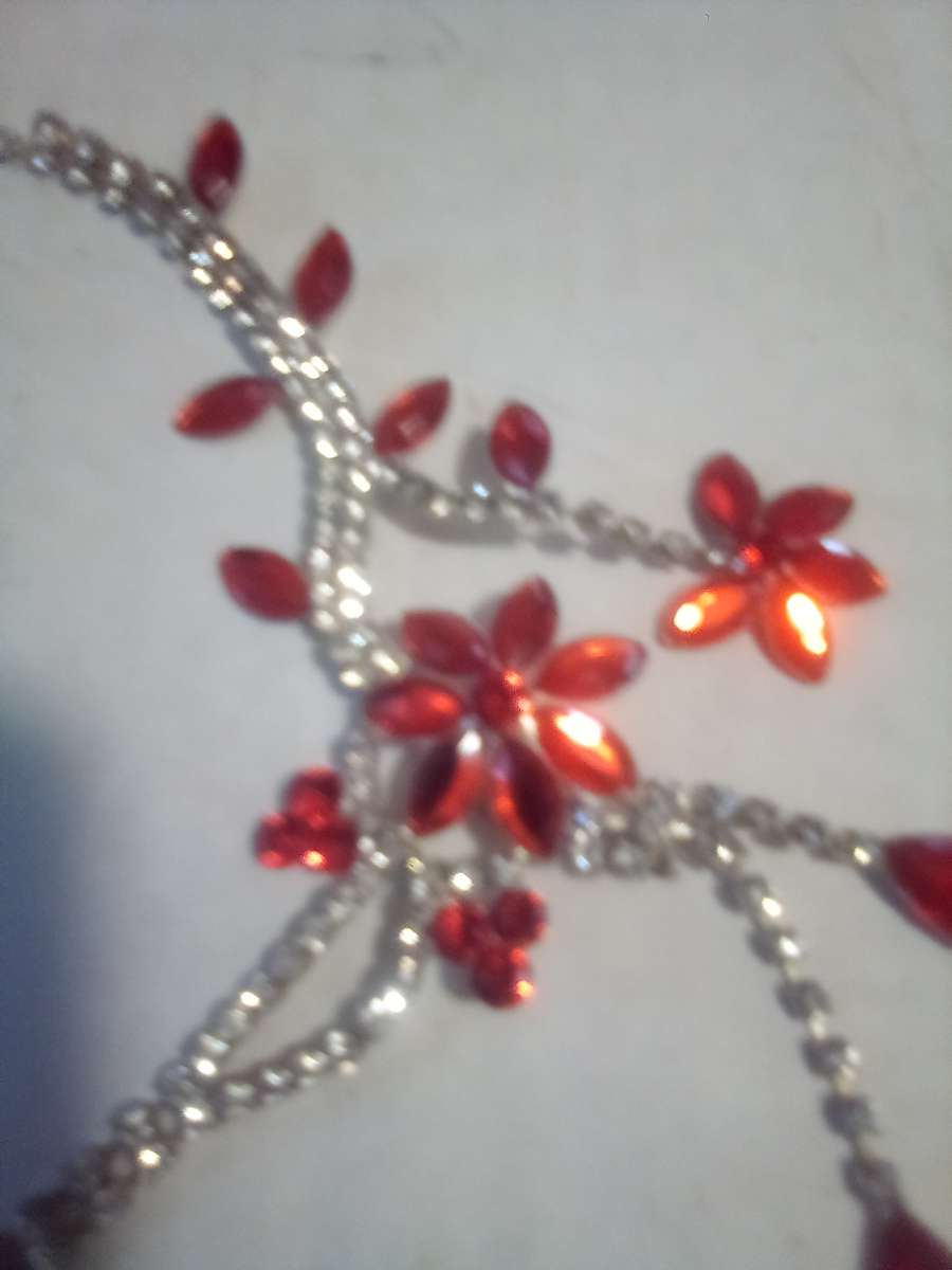 Orange hanging flower and gold necklace with diamonds