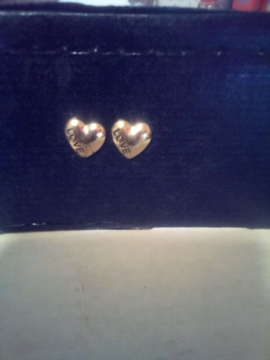 eartshape gold earrings with love written inside