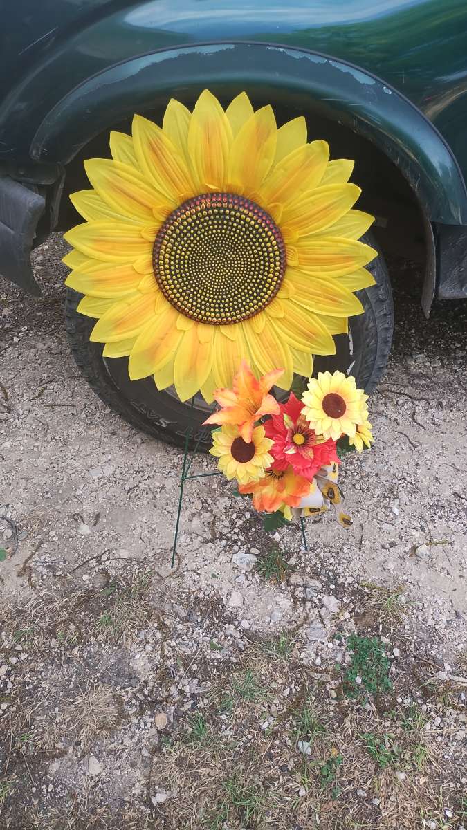 assorted flowers stands  virgin Mary pot