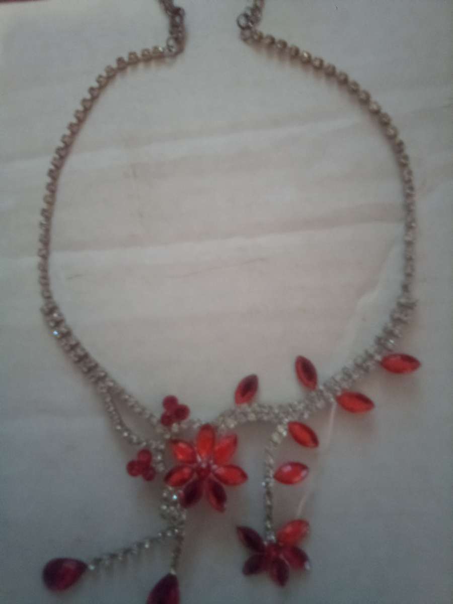 Orange hanging flower and gold necklace with diamonds