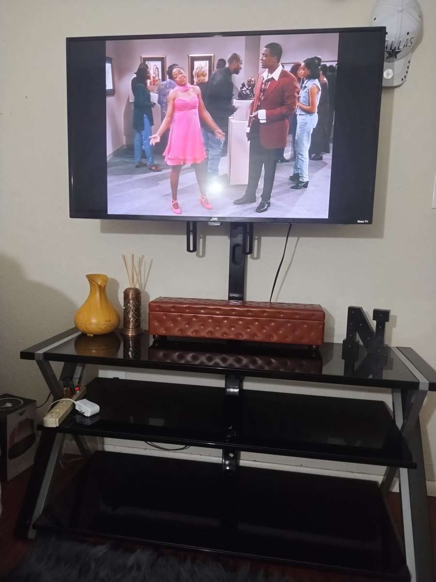 a Roku 45in TV with remote control and TV stand