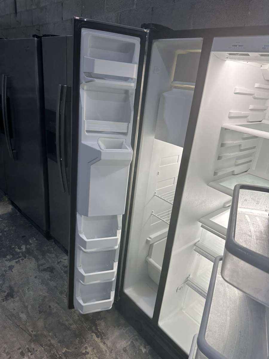 GE refrigerator side by side with water and ice maker dispen