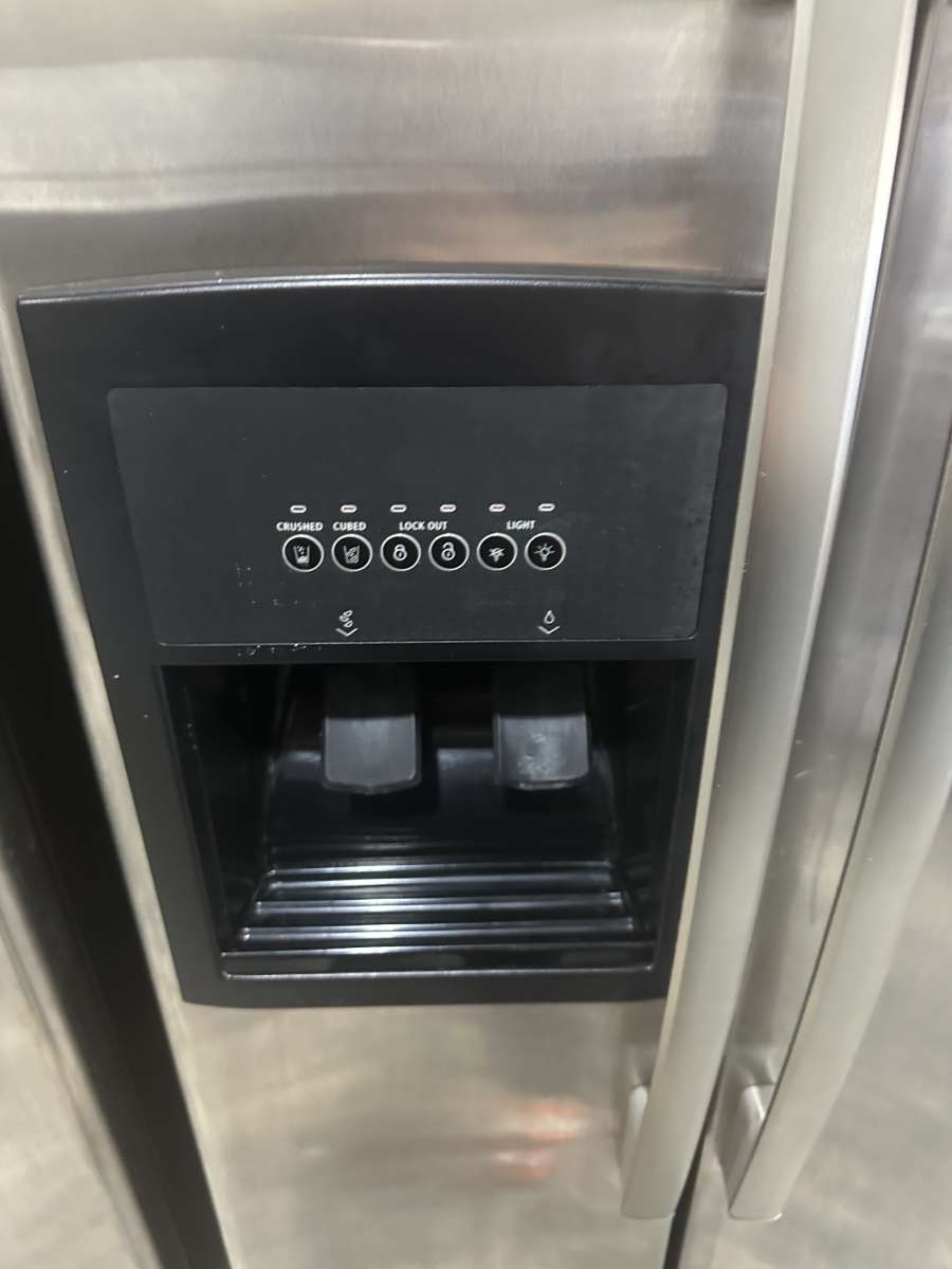 GE refrigerator side by side with water and ice maker dispen