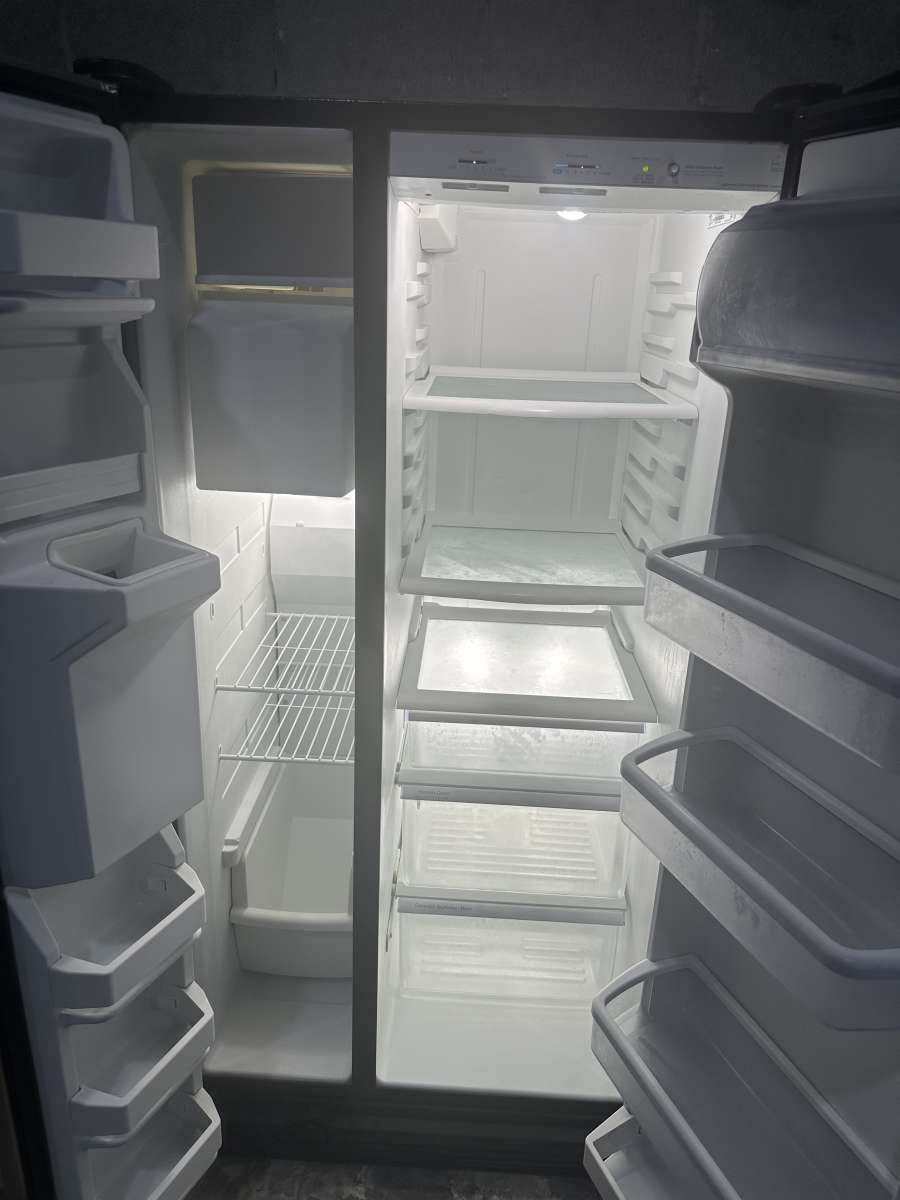 GE refrigerator side by side with water and ice maker dispen