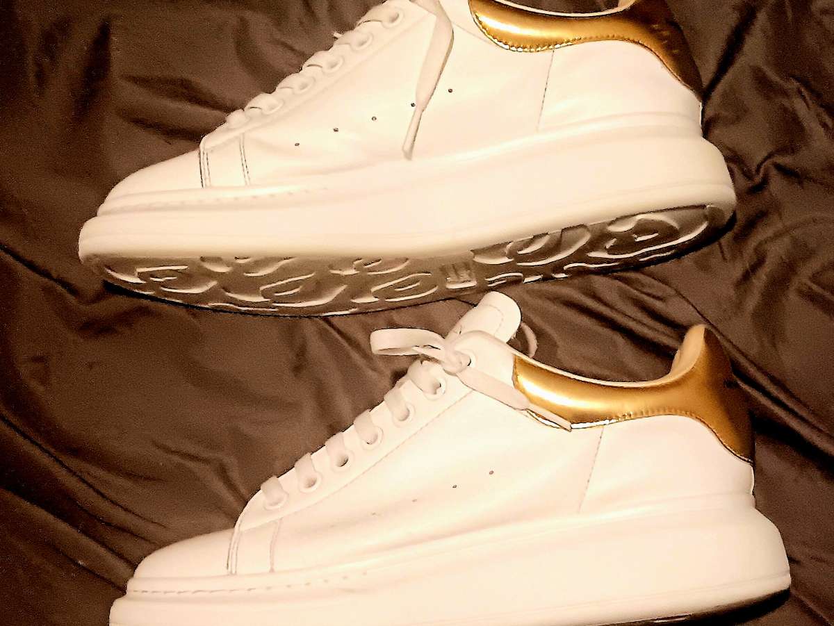 a pair of Alexander McQueen sneakers  size 9