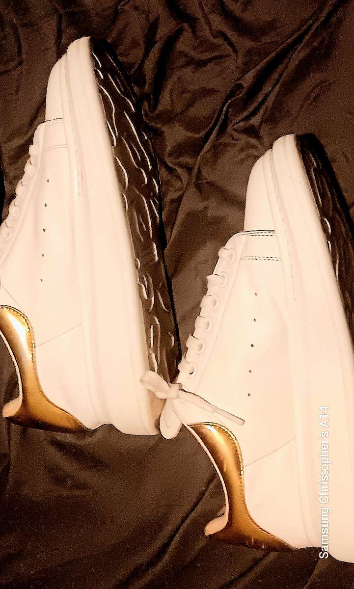 a pair of Alexander McQueen sneakers  size 9