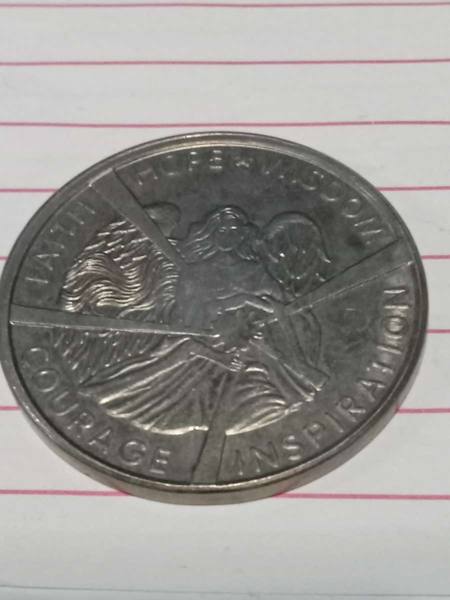 metal coin with  woman on it