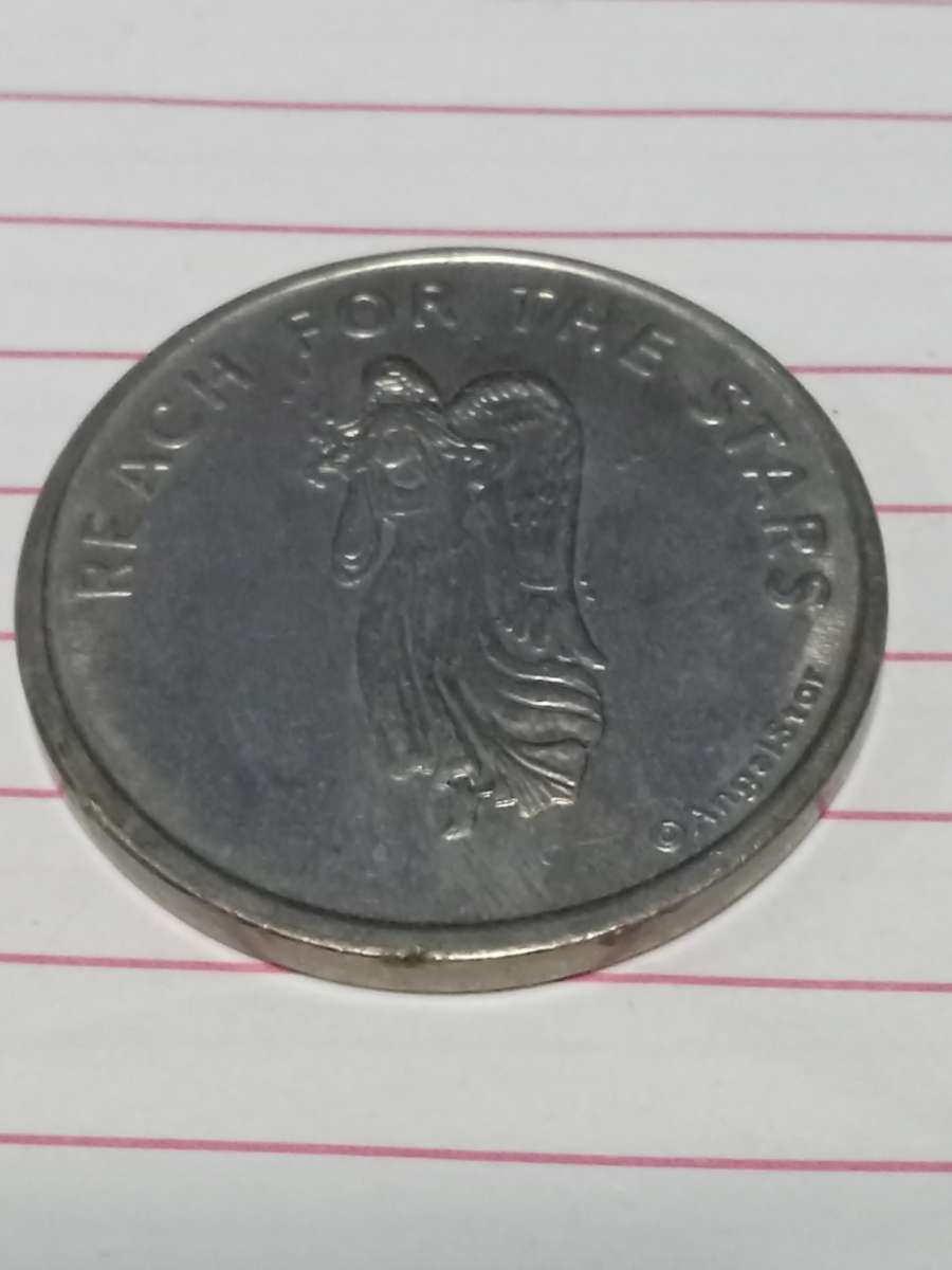 metal coin with  woman on it