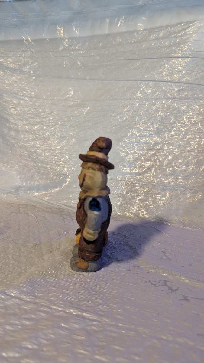 Happy Wood Scarecrow has a couple of Pumpkins and a little S