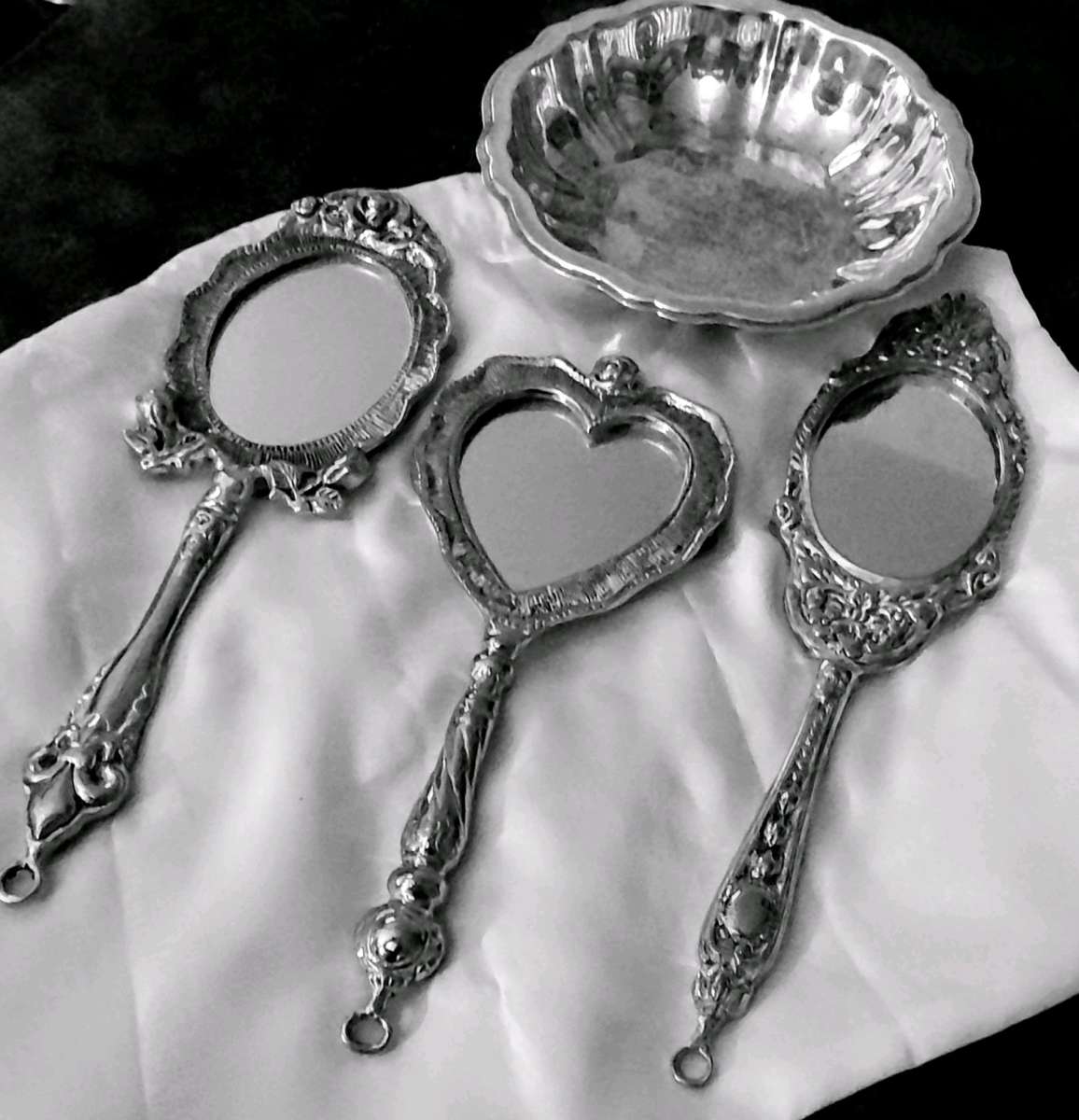 vintage handheld mirrors made by twos company and a bowl