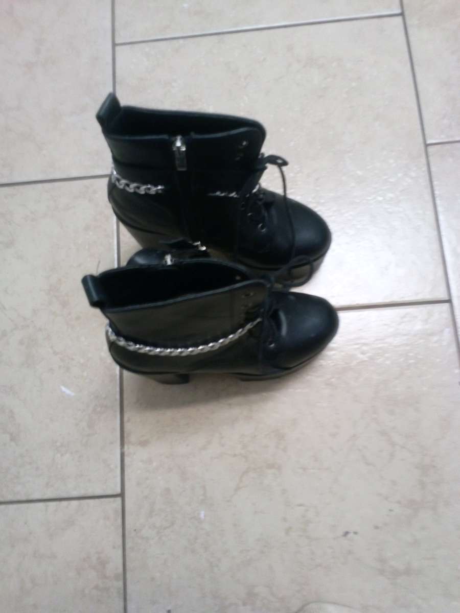 a pair of black platform boots high heeled