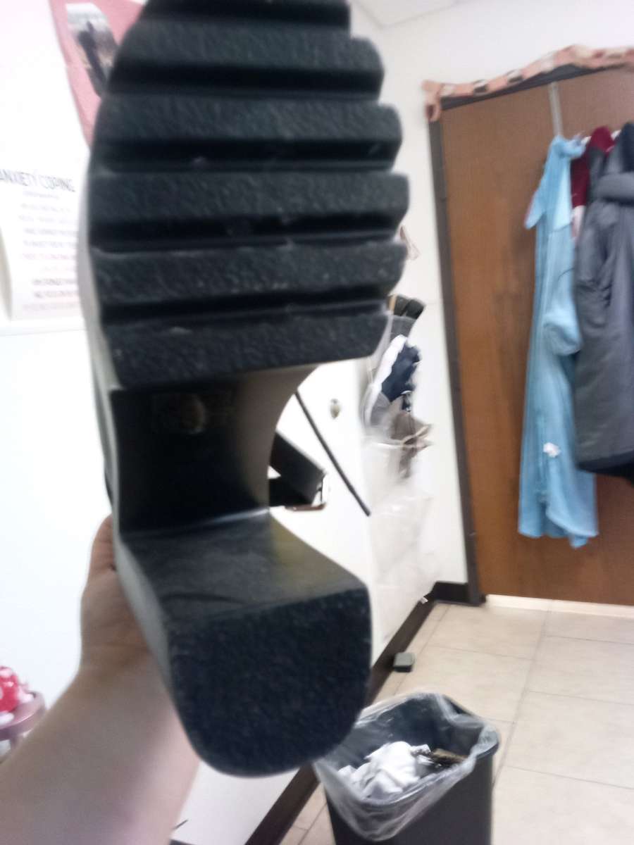 a pair of black platform boots high heeled