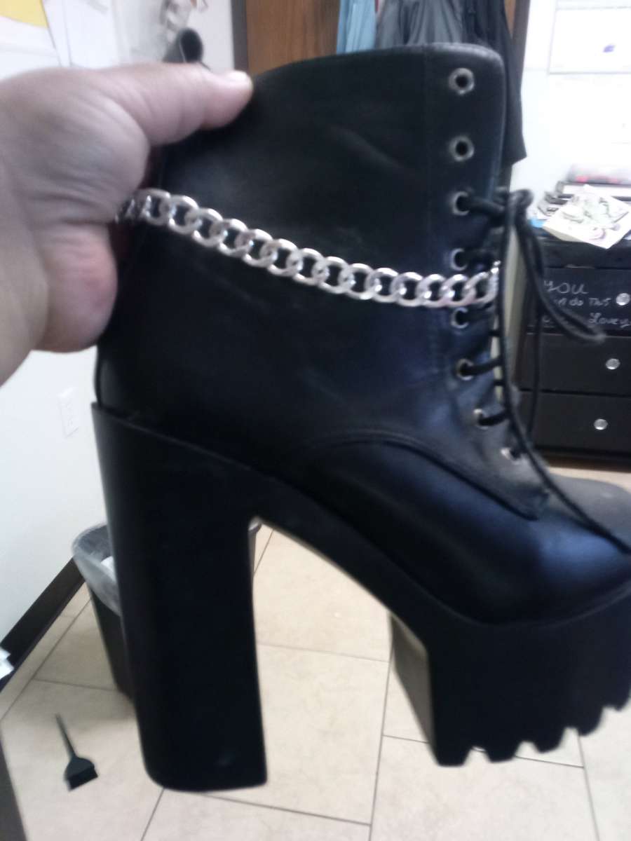 a pair of black platform boots high heeled