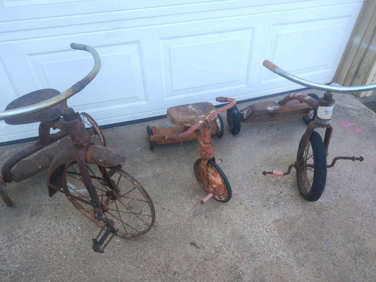 antique tricycle and a antique grape soda cooler