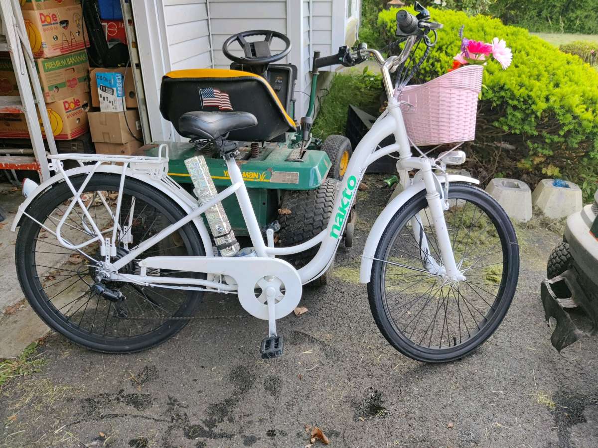 White used ebike with pink basket