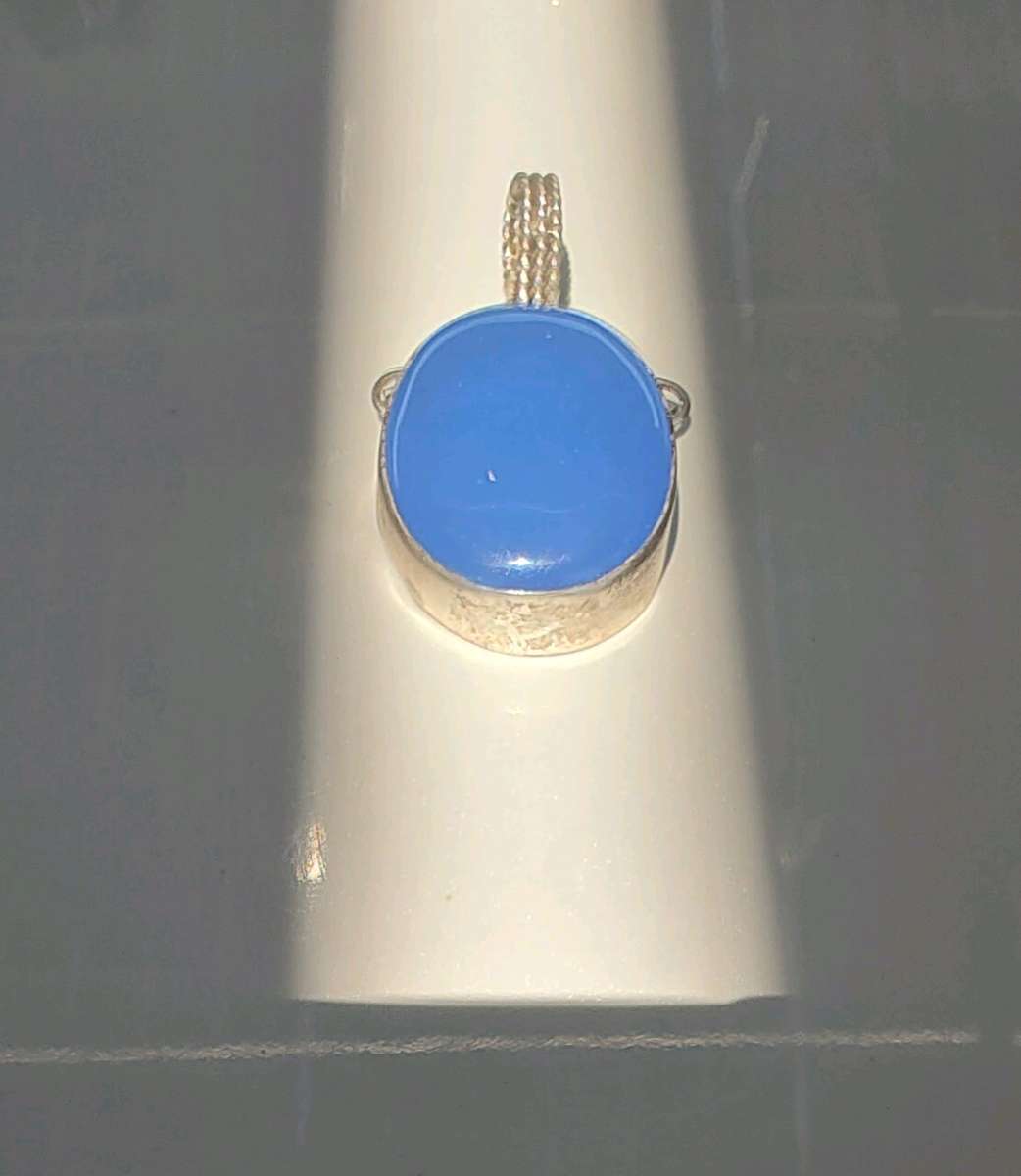 large blue opal cabochon set in sterling silver pendant
