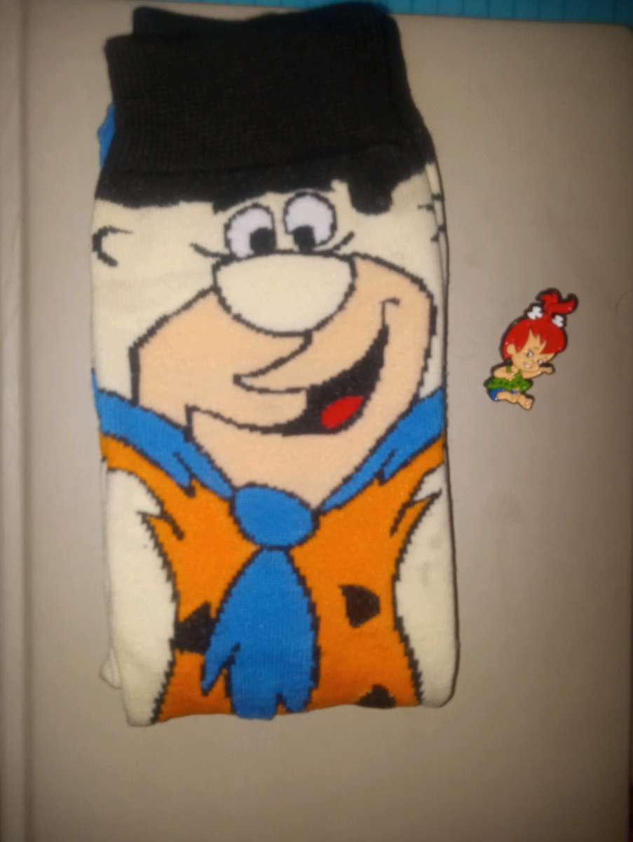 Fred Flintstone socks collectible with a pebbles pin