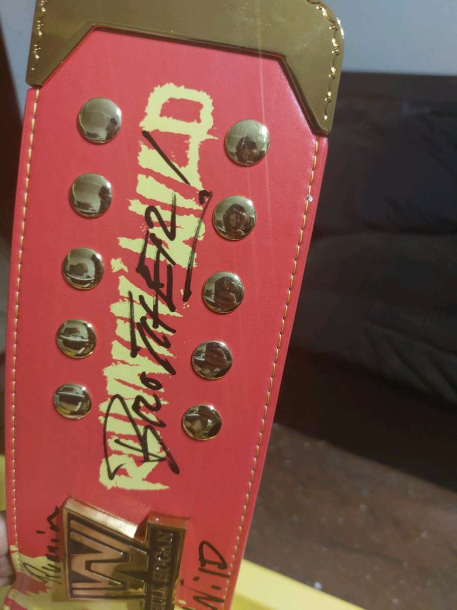 red and yellow winged eagle autographed Hulk Hogan Hall of F