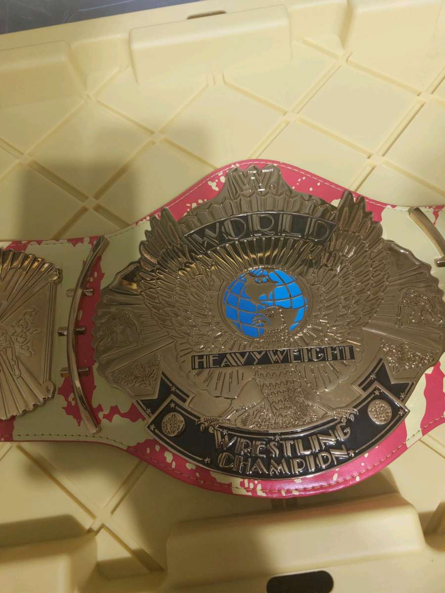 red and yellow winged eagle autographed Hulk Hogan Hall of F